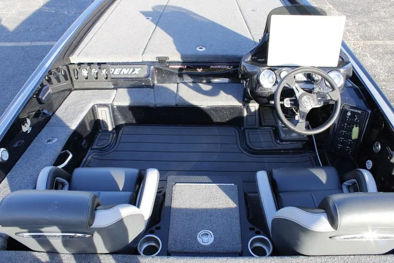 Slide: The Image of 2025 Phoenix 921 ELITE boat interior with steering wheel and seating. - 19