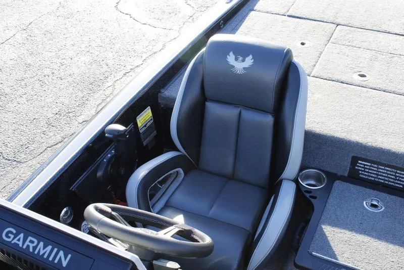 Slide: The Image of 2025 Phoenix 921 ELITE boat cockpit with steering wheel and seat. - 22
