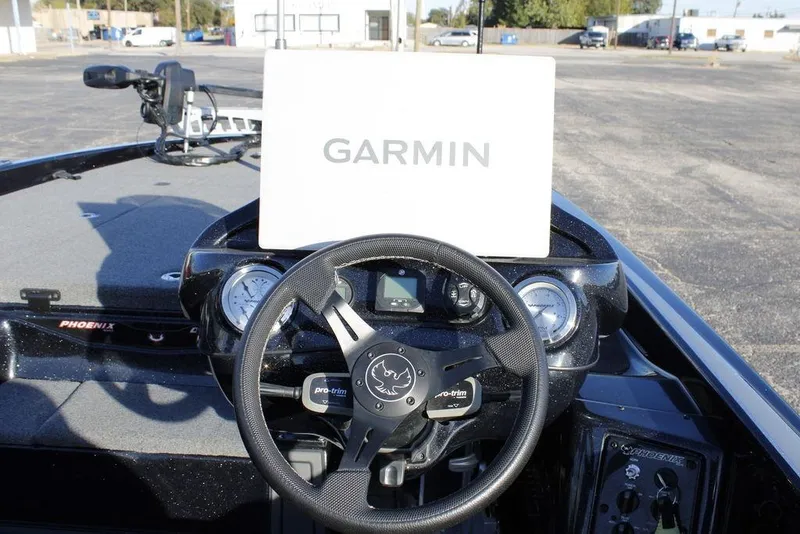 Slide: The Image of 2025 Phoenix 921 ELITE boat dashboard with Garmin display and steering wheel. - 26