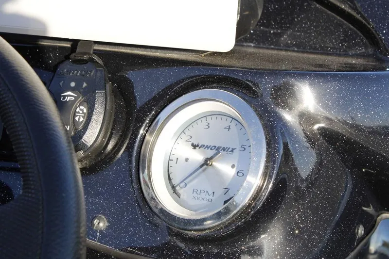 Slide: The Image of Close-up of 2025 Phoenix 921 ELITE boat dashboard with RPM gauge. - 28