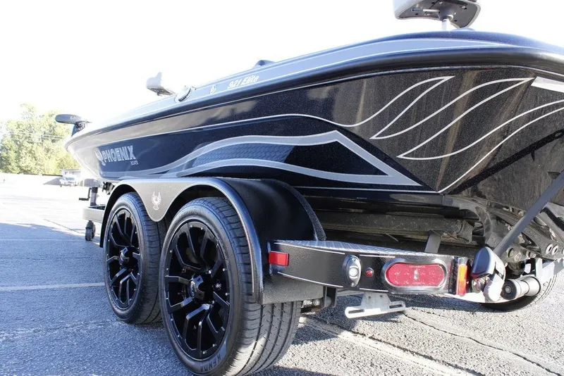 Slide: The Image of 2025 Phoenix 921 ELITE boat on trailer with stylish black wheels and sleek design. - 4
