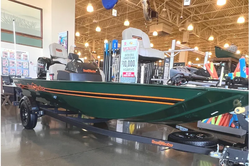The Image of 2026 Tracker Bass Tracker Classic Limited boat displayed in a showroom with promotional signage. - 0