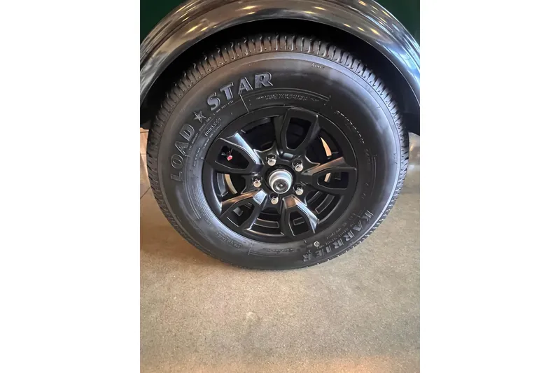 Slide: The Image of 2026 Tracker Bass Tracker Classic Limited trailer tire with black alloy wheel. - 4