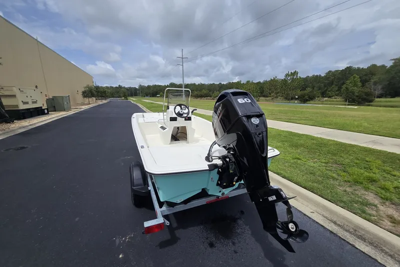 Slide: The Image of 2026 Mako Pro Skiff 15 CC boat with outboard motor on a trailer. - 3