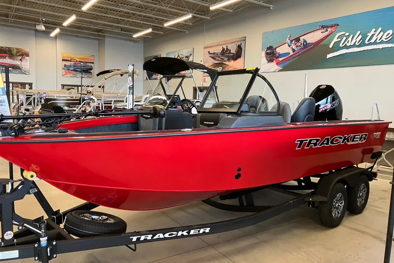 The Image of 2026 Tracker Targa V-19 Combo boat in showroom, vibrant red color, sleek design. - 0