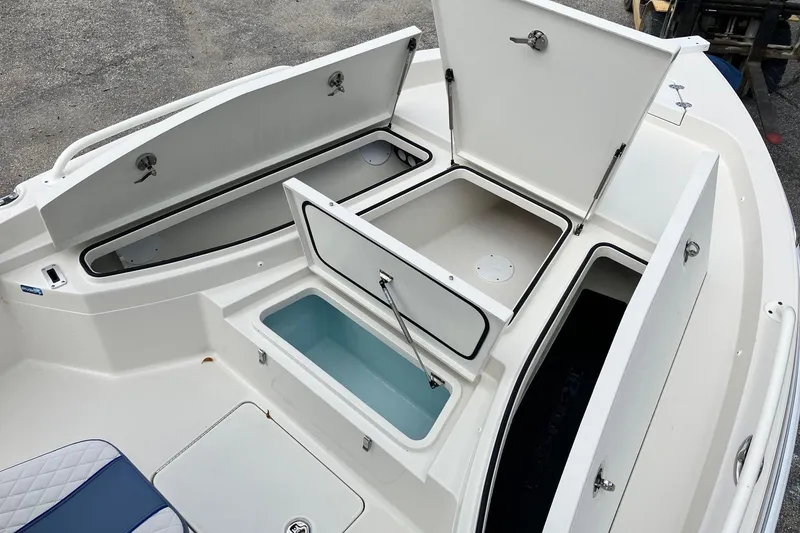 Slide: The Image of 2026 Ranger 2510 Bay boat with open storage compartments and seating area. - 12