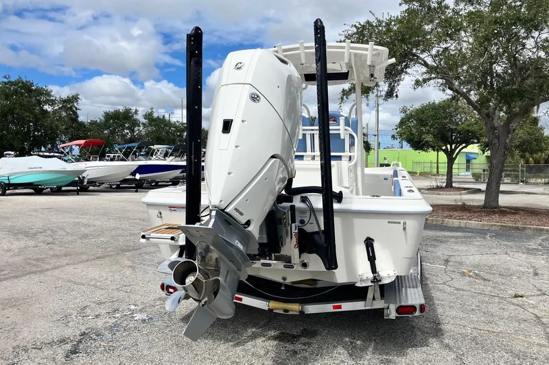 Slide: The Image of 2026 Ranger 2510 Bay boat with powerful outboard motor in a parking lot. - 5