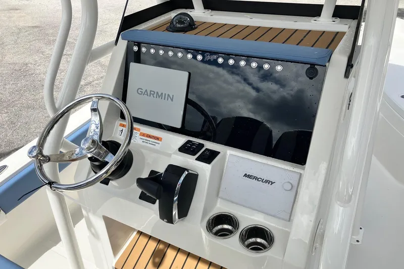 Slide: The Image of 2026 Ranger 2510 Bay boat dashboard with Garmin and Mercury controls. - 8