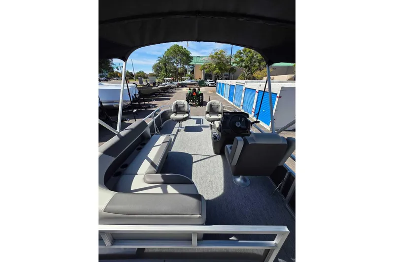 Slide: The Image of 2026 Sun Tracker Bass Buggy 16 XL Select pontoon boat interior with seating and steering console. - 4
