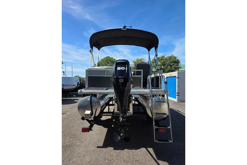 Slide: The Image of 2026 Sun Tracker Bass Buggy 16 XL Select pontoon boat with outboard motor and canopy. - 5