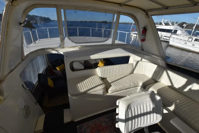 Slide: The Image of 1993 Ocean Yachts 44 Aft Cabin interior with white seating, overlooking marina. - 10