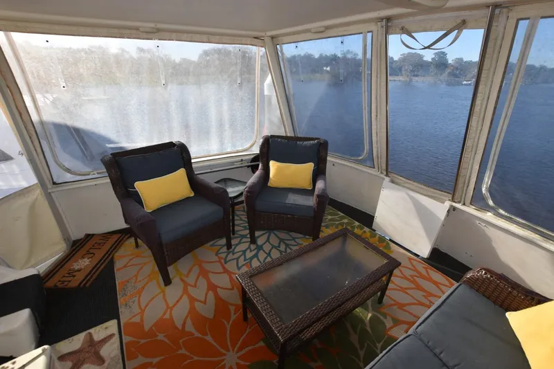 Slide: The Image of 1993 Ocean Yachts 44 Aft Cabin interior with wicker furniture and lake view. - 13