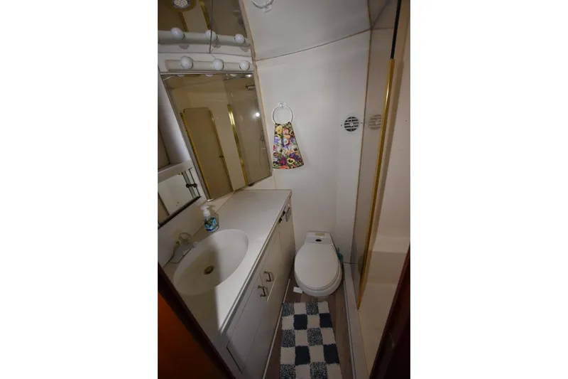 Slide: The Image of Bathroom in 1993 Ocean Yachts 44 Aft Cabin with sink, toilet, and shower. - 25