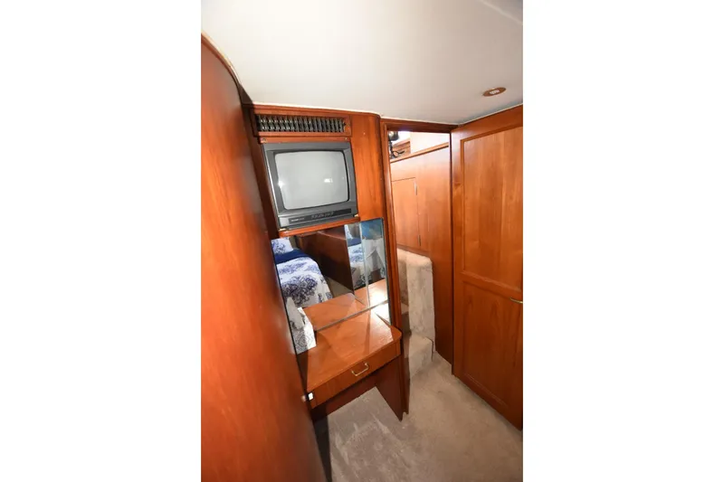Slide: The Image of 1993 Ocean Yachts 44 Aft Cabin interior with TV, wood cabinetry, and mirror. - 26