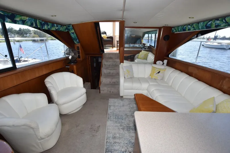 Slide: The Image of Luxurious 1993 Ocean Yachts 44 Aft Cabin interior with white seating and scenic water views. - 32