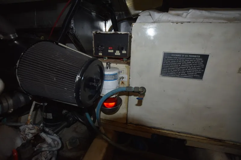 Slide: The Image of Engine room of 1993 Ocean Yachts 44 Aft Cabin with oil discharge warning sign. - 35