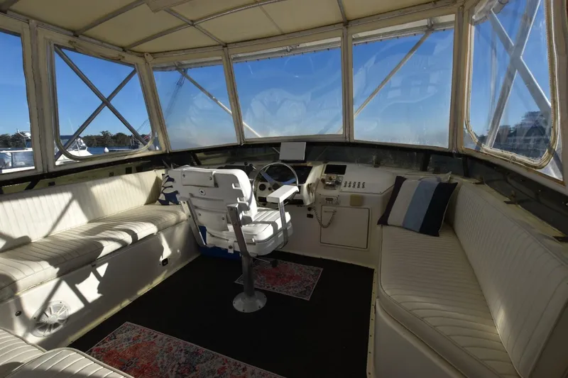 Slide: The Image of 1993 Ocean Yachts 44 Aft Cabin interior with helm, seating, and panoramic windows. - 9