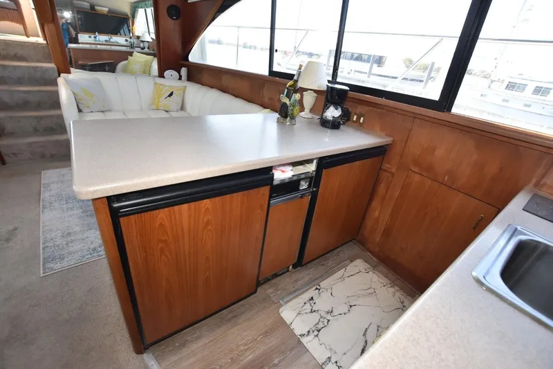 Slide: The Image of Interior of 1993 Ocean Yachts 44 Aft Cabin with kitchen and seating area. - 20