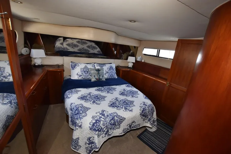 Slide: The Image of Luxurious 1993 Ocean Yachts 44 Aft Cabin bedroom with elegant bedding and wood cabinetry. - 22