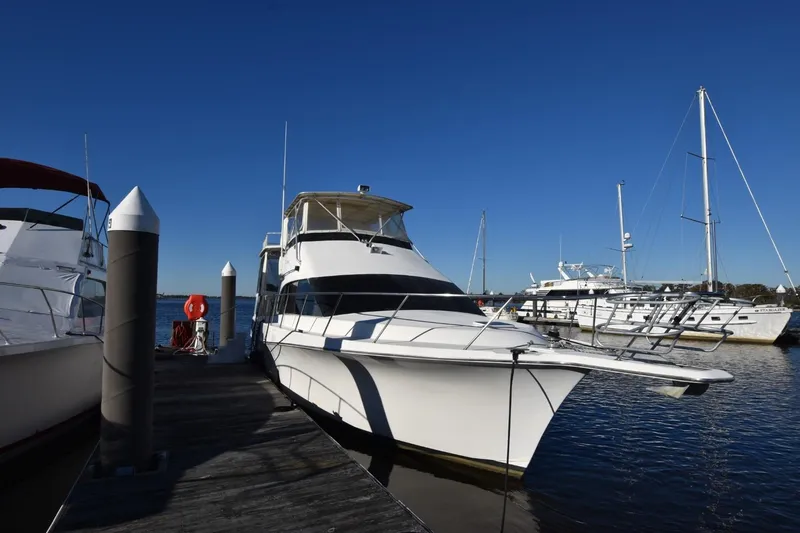 Slide: The Image of 1993 Ocean Yachts 44 Aft Cabin docked at marina under clear blue sky. - 1
