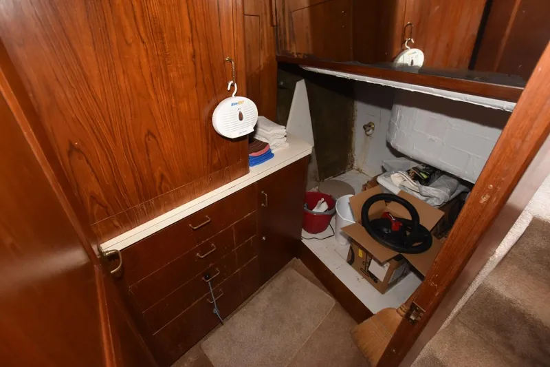 Slide: The Image of 1993 Ocean Yachts 44 Aft Cabin interior storage area with wooden cabinets and miscellaneous items. - 18