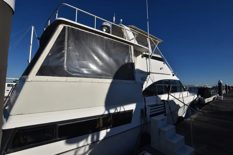 Slide: The Image of 1993 Ocean Yachts 44 Aft Cabin docked under clear blue sky. - 2