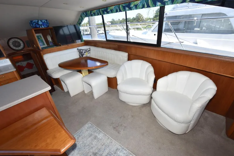Slide: The Image of Luxurious 1993 Ocean Yachts 44 Aft Cabin interior with white seating and wooden accents. - 24