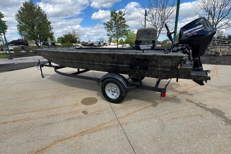 Slide: The Image of 2026 Tracker Grizzly 1654 T Sportsman boat on trailer, outdoors under cloudy sky. - 5