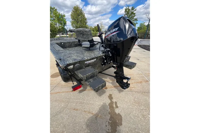Slide: The Image of 2026 Tracker Grizzly 1654 T Sportsman boat with Mercury engine on concrete surface. - 6