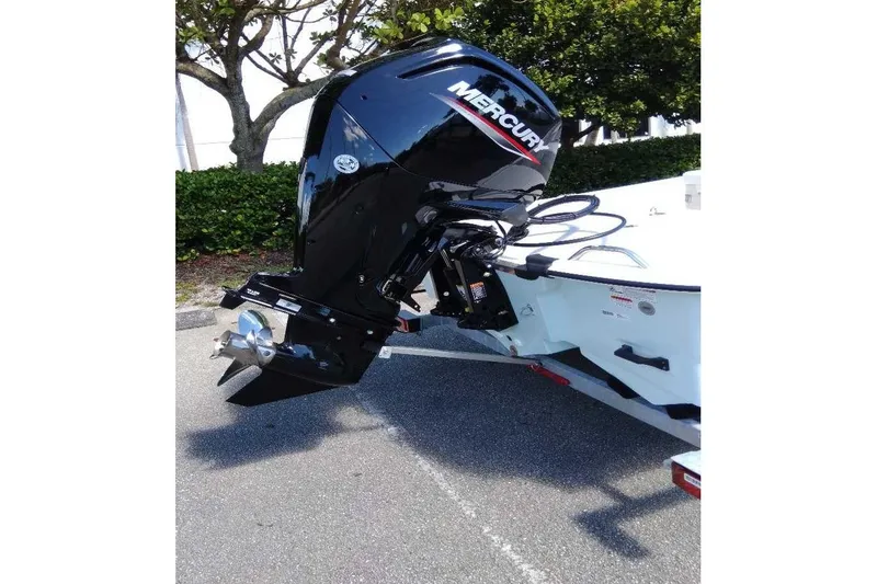 Slide: The Image of 2026 Mako Pro Skiff 17 CC with Mercury outboard motor, parked on a trailer. - 10