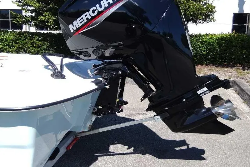 Slide: The Image of 2026 Mako Pro Skiff 17 CC with Mercury outboard motor in sunlight. - 11