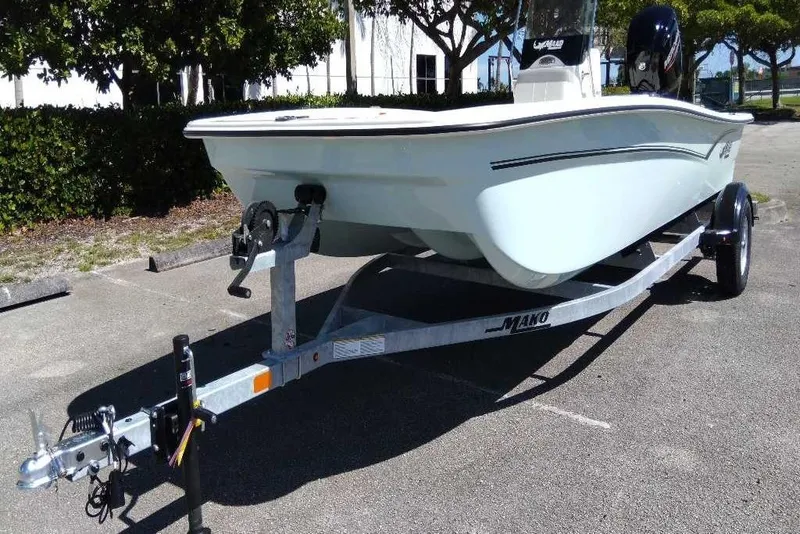 Slide: The Image of 2026 Mako Pro Skiff 17 CC boat on trailer, parked outdoors. - 2