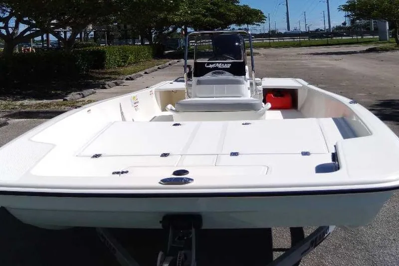 Slide: The Image of 2026 Mako Pro Skiff 17 CC boat on trailer, parked outdoors. - 4