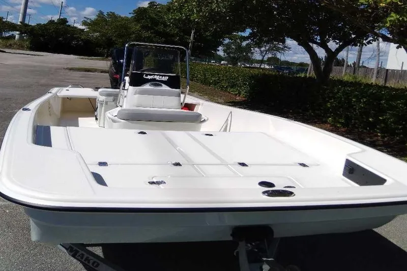 Slide: The Image of 2026 Mako Pro Skiff 17 CC boat parked outdoors, showcasing sleek design and spacious deck. - 6