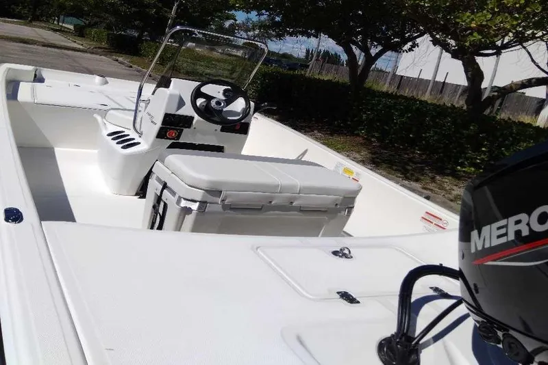 Slide: The Image of 2026 Mako Pro Skiff 17 CC boat with Mercury engine, white interior, and center console. - 7