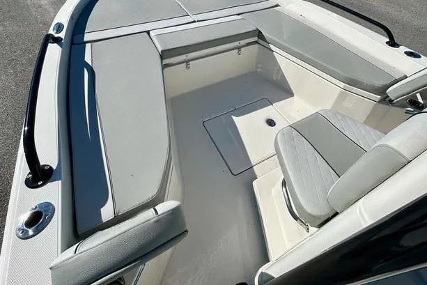Slide: The Image of 2026 Ranger 2360 Bay boat interior with cushioned seating and storage compartments. - 14