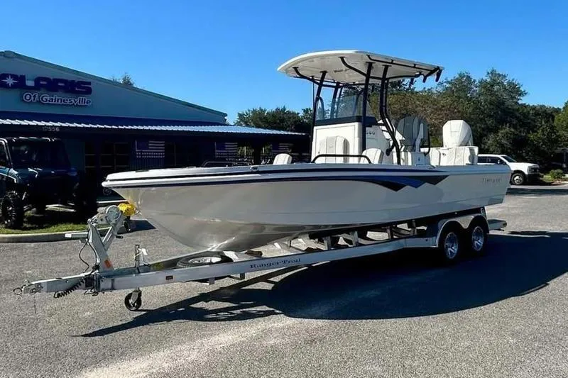 Slide: The Image of 2026 Ranger 2360 Bay boat on trailer, parked outside dealership. - 3
