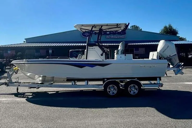 Slide: The Image of 2026 Ranger 2360 Bay boat on trailer, parked outdoors, side view. - 4