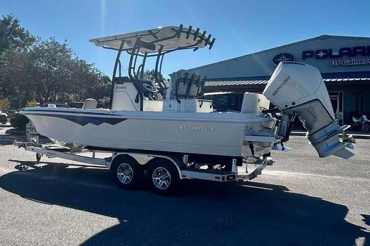 Slide: The Image of 2026 Ranger 2360 Bay boat on trailer, parked outdoors near dealership. - 5