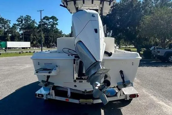 Slide: The Image of 2026 Ranger 2360 Bay boat, rear view with outboard motor, parked outdoors. - 6
