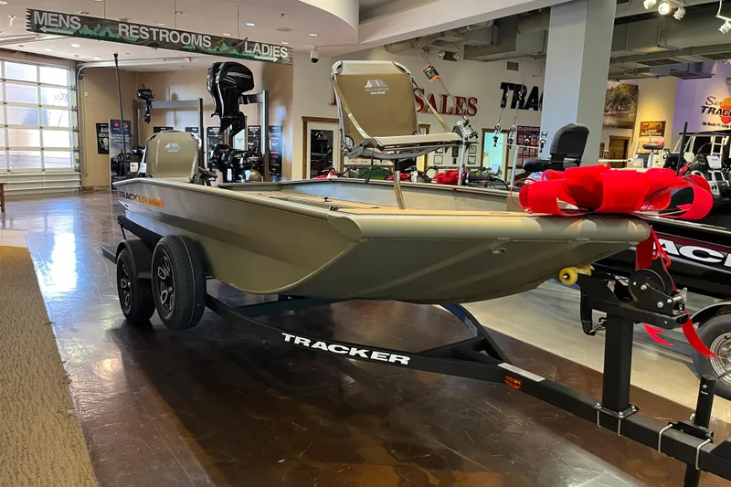 The Image of 2026 Tracker Grizzly 1756 T Marsh boat displayed indoors with a red bow. - 0