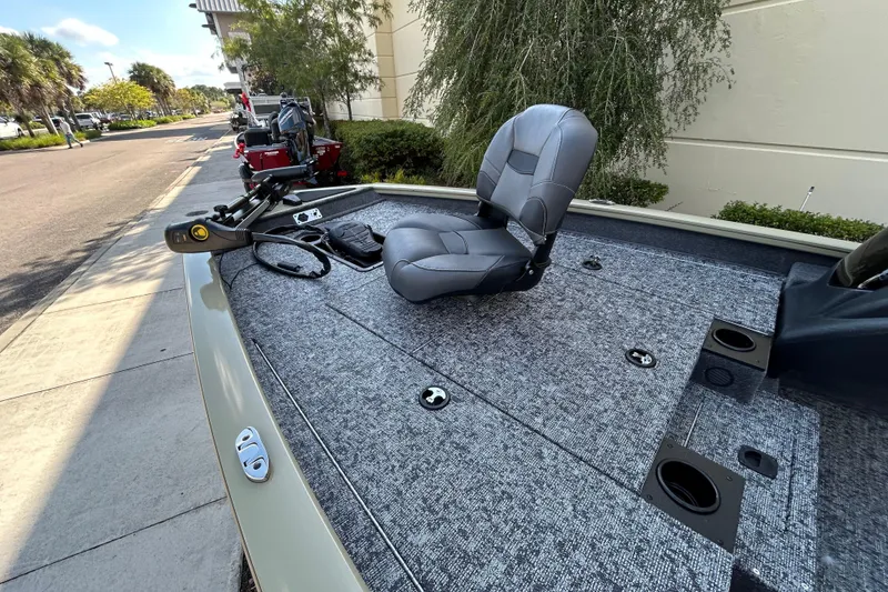 Slide: The Image of 2026 Tracker Pro Team 175 boat with seating and fishing deck, parked outdoors. - 3