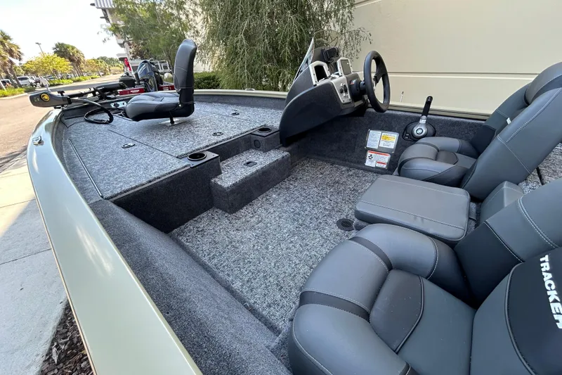 Slide: The Image of 2026 Tracker Pro Team 175 boat interior with gray seating and steering console. - 4