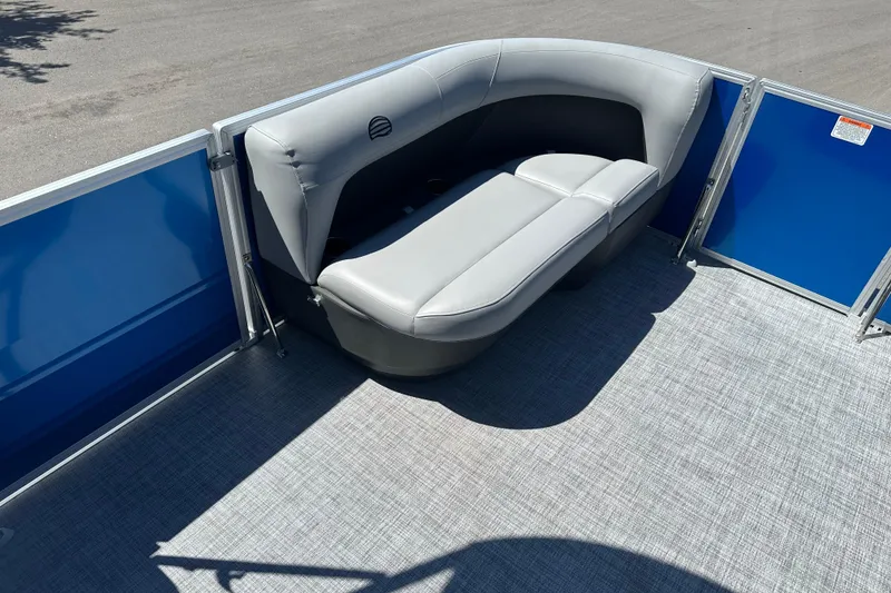 Slide: The Image of 2026 Sun Tracker Party Barge 16 DLX with gray seating and blue paneling. - 8