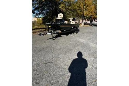 The Image of 2026 Tracker Bass Tracker Classic Limited boat on a trailer in a parking lot. - 0