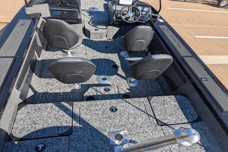 Slide: The Image of 2026 Tracker Targa V-19 Combo boat interior with four seats and steering console. - 5