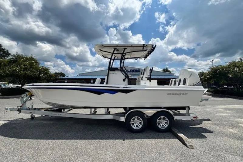 The Image of 2026 Ranger 2360 Bay boat on trailer under cloudy sky. - 0