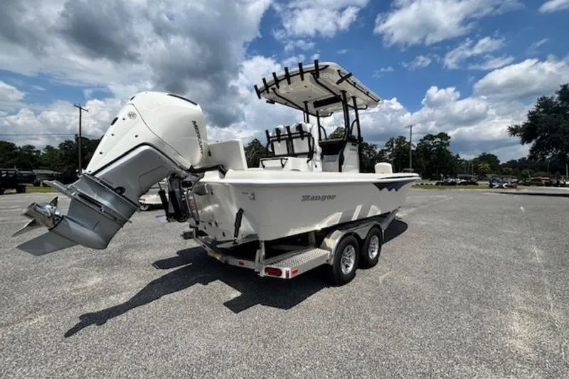 Slide: The Image of 2026 Ranger 2360 Bay boat on trailer under a partly cloudy sky. - 5