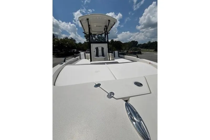 Slide: The Image of 2026 Ranger 2360 Bay boat with T-top, viewed from the deck under a blue sky. - 8