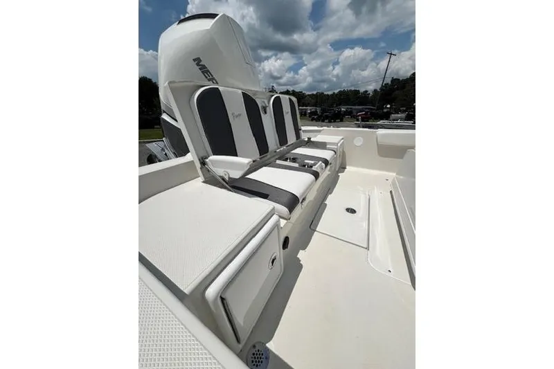 Slide: The Image of 2026 Ranger 2360 Bay boat interior with cushioned seating and Mercury engine. - 9